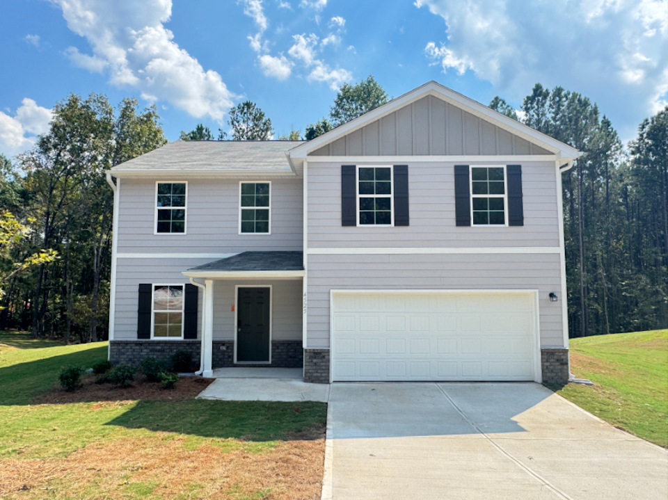 A white house with a garage.