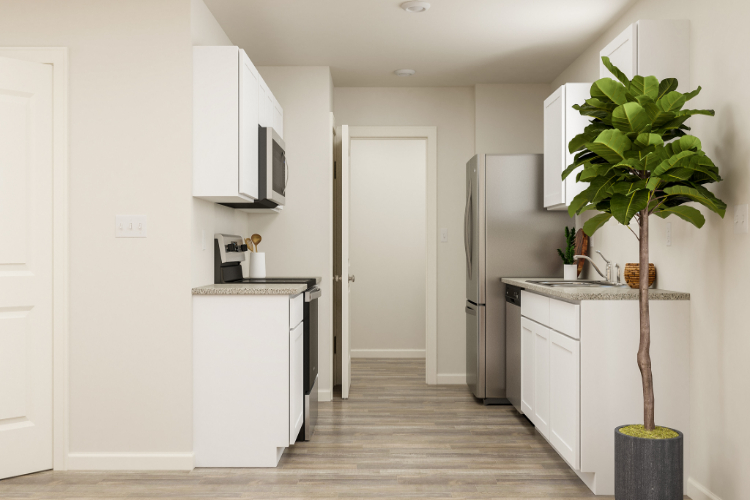 A kitchen with white cabinets.