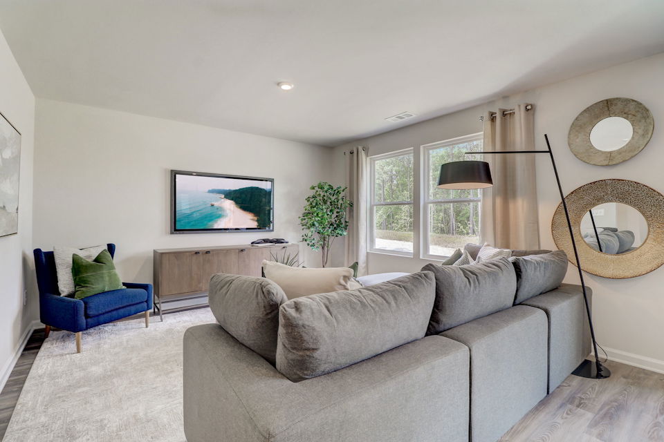 A living room with a couch and a tv.