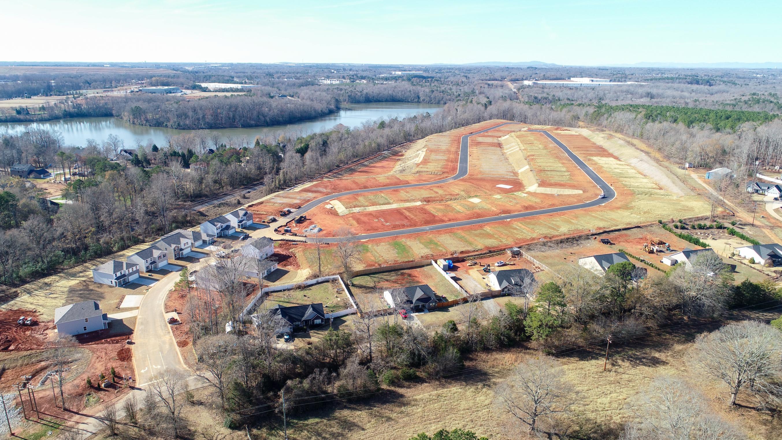A landscape with a river and houses.