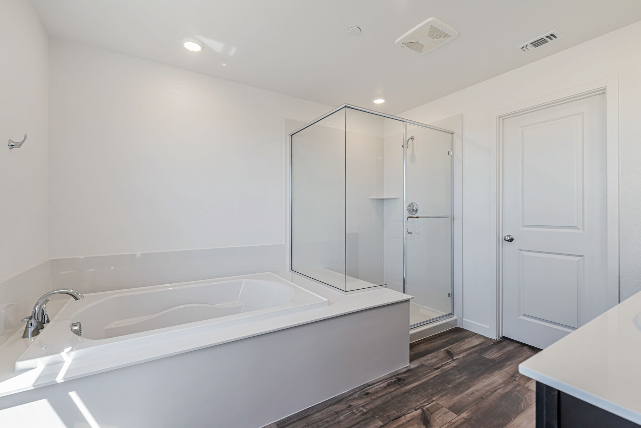A bathroom with a tub and shower.