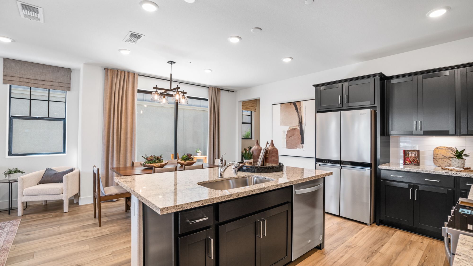 A kitchen with black cabinets.